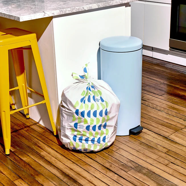 Who Gives a Crap large recycled rubbish bag sits full next to kitchen